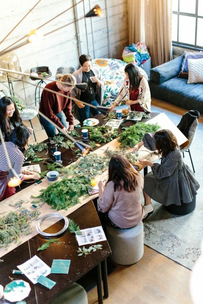 women crafting with greenery at workshop table